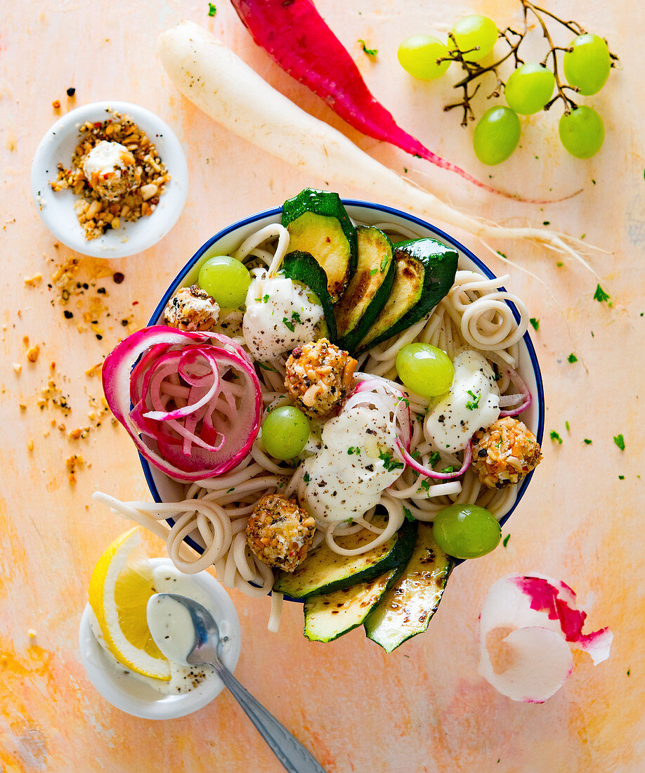 Pasta bowl with radish, courgette, grapes and nut cream cheese