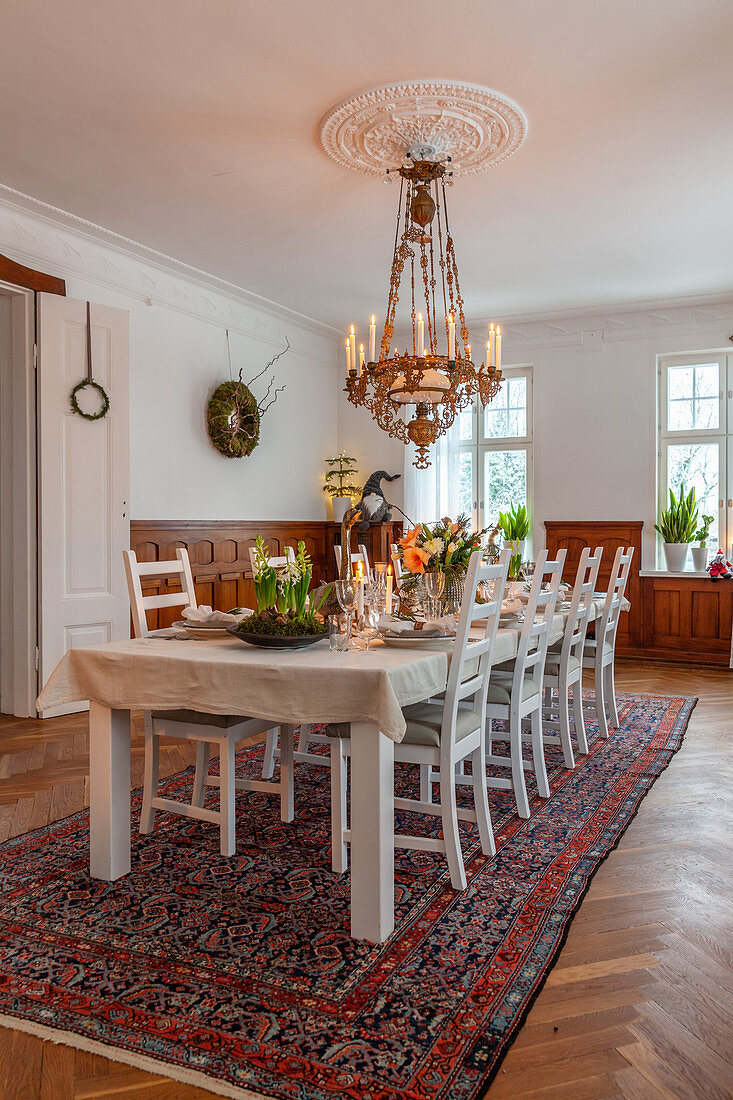 Festively set table in dining room with chandelier