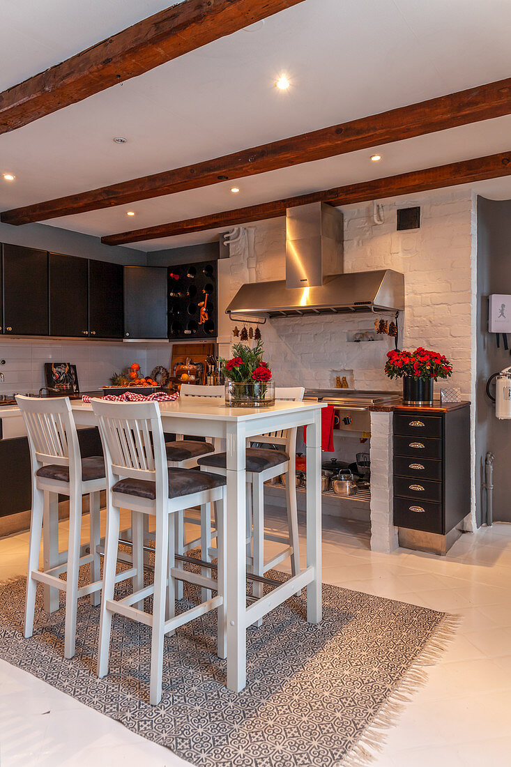 Tall table and bar stools in modern country-house kitchen