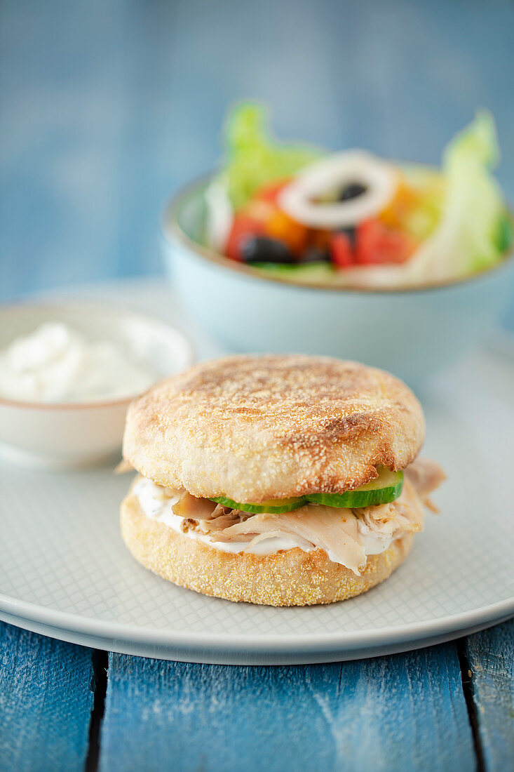 A toastie burger with chicken, mint quark and Greek salad