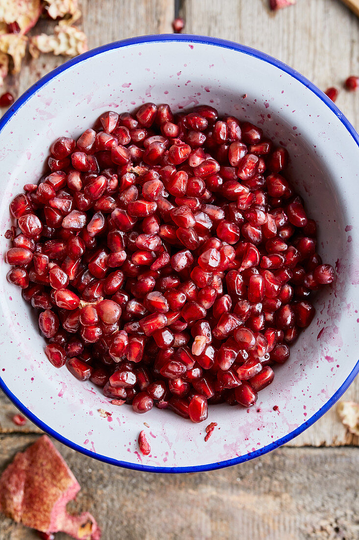 Fresh peeled pomegranate in a white bowl