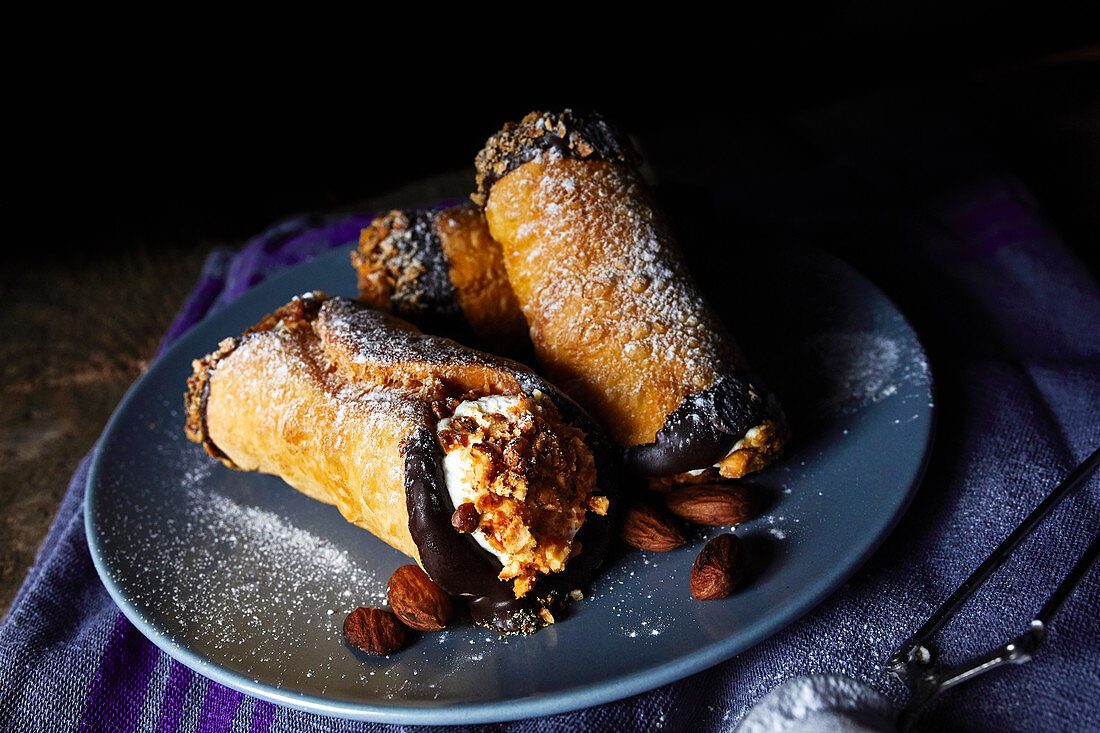 Sicilian cannoli with ricotta filling and chopped almonds (Italy)