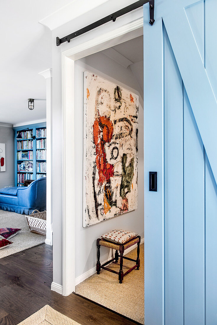 Living room with blue sliding door to the TV room in a converted garage