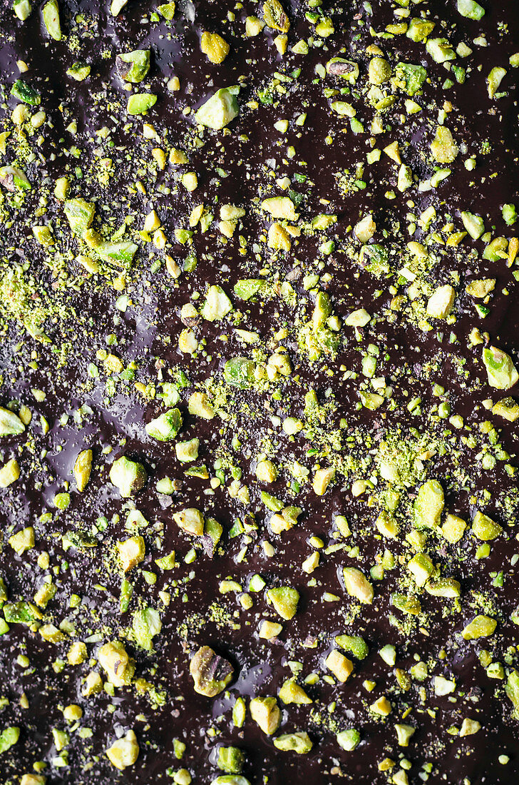 Chopped Pistachios on Melted Dark Chocolate