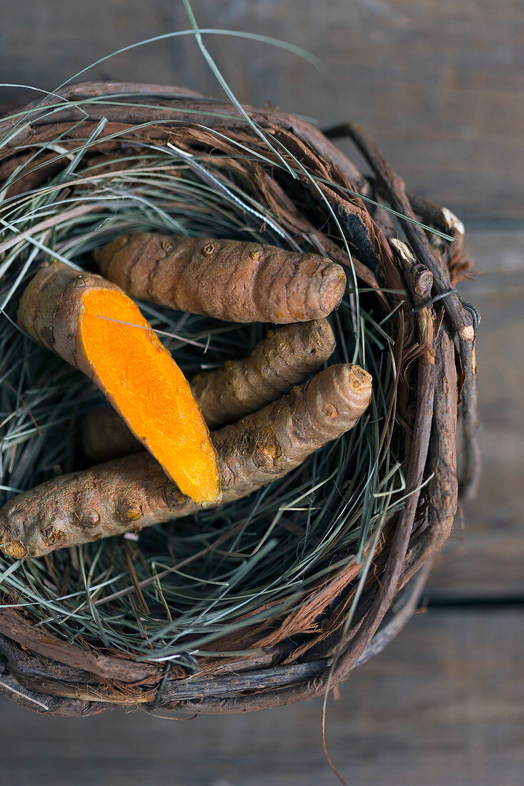 Yummy boiled carrot placed inside small nest on lumber tabletop