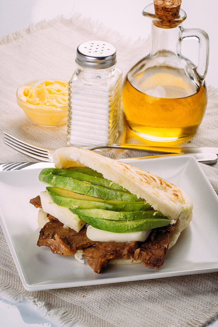 Delicious Arepa stuffed with avocado, cheese and meat