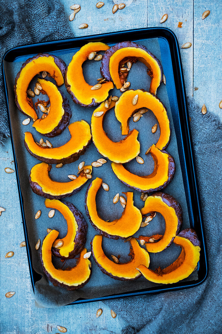 Slices of pumpkin on a baking tray
