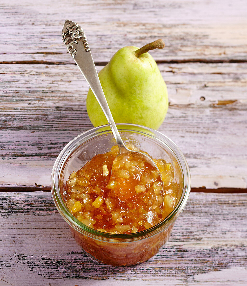 Homemade pear jam on a wooden background
