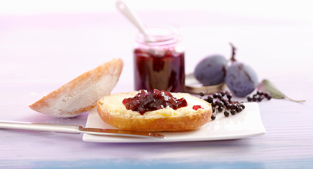 Damson and elderberry jam on a bread roll