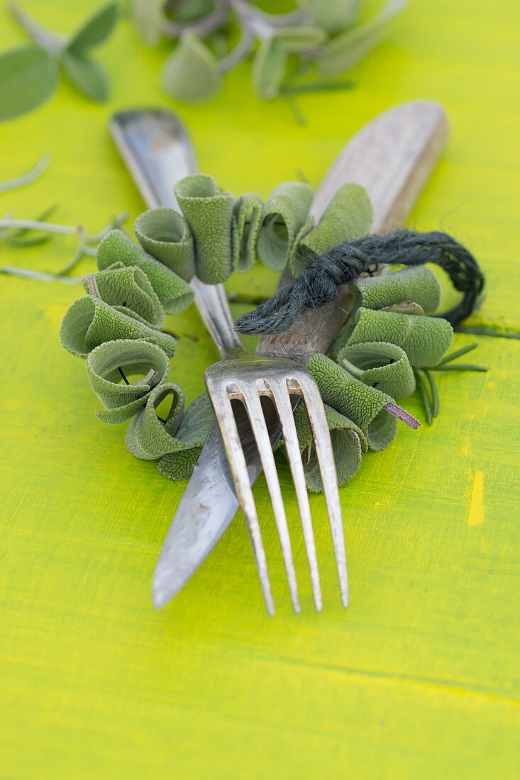 A wreath of sage with a knife and fork