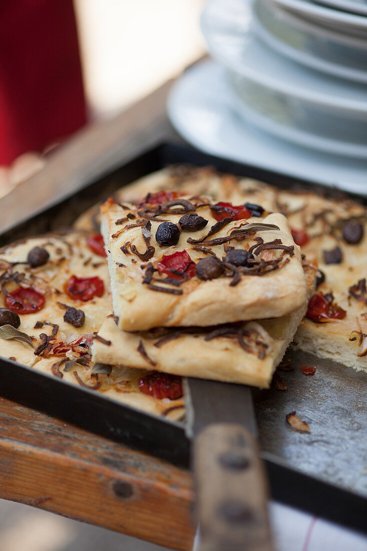 Freshly baked focaccia with tomatoes and olives