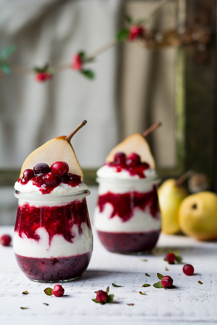 Yoghurt with cranberries and pears in glasses