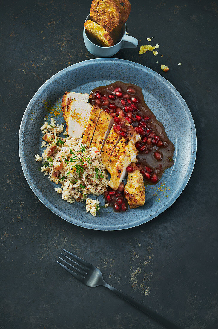 Chicken breast with couscous salad and pomegranate sauce