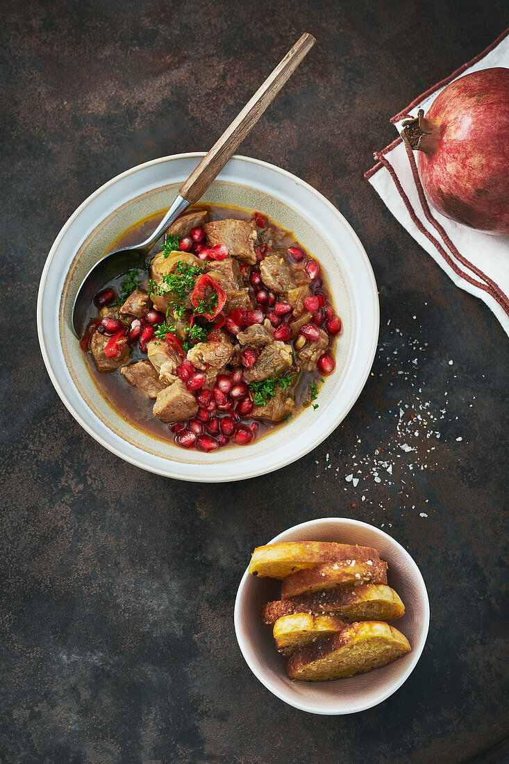 Pork goulash with pomegranate seeds