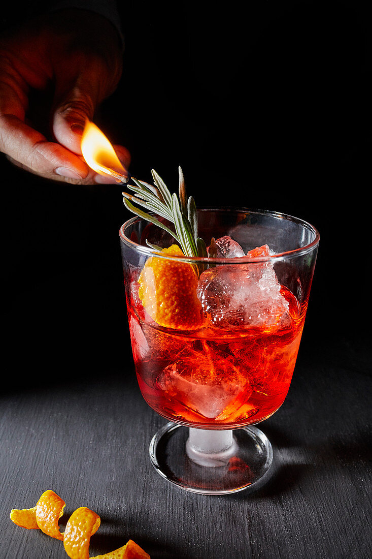 Negroni, served with a rosemary sprig