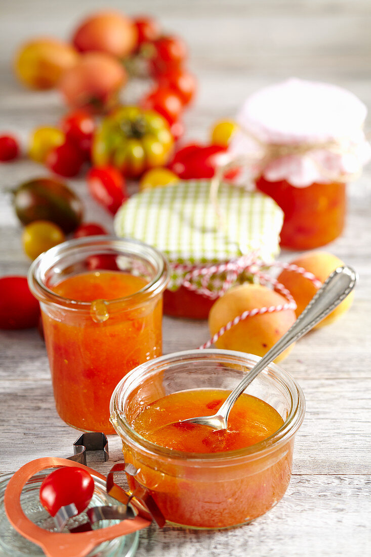 Homemade apricot and tomato jam in preserving jars