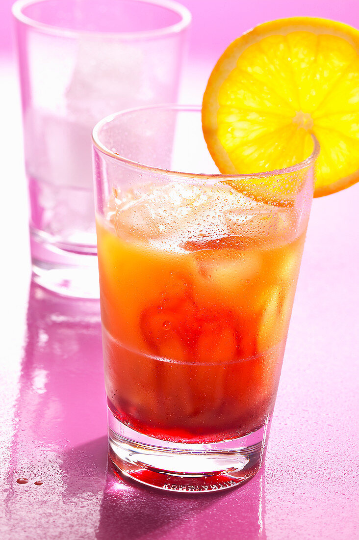 A Tequila Sunrise made with lemon juice, orange juice and grenadine