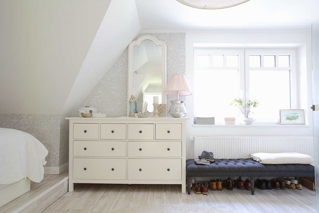 Chest of drawers and bench in bright bedroom
