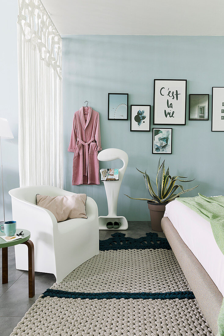 Pale blue walls and curtain for separating sleeping area in loft apartment