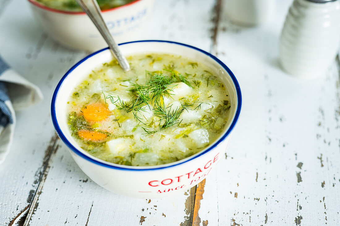 Simple polish style kohlrabi and dill soup in two vintage bowls