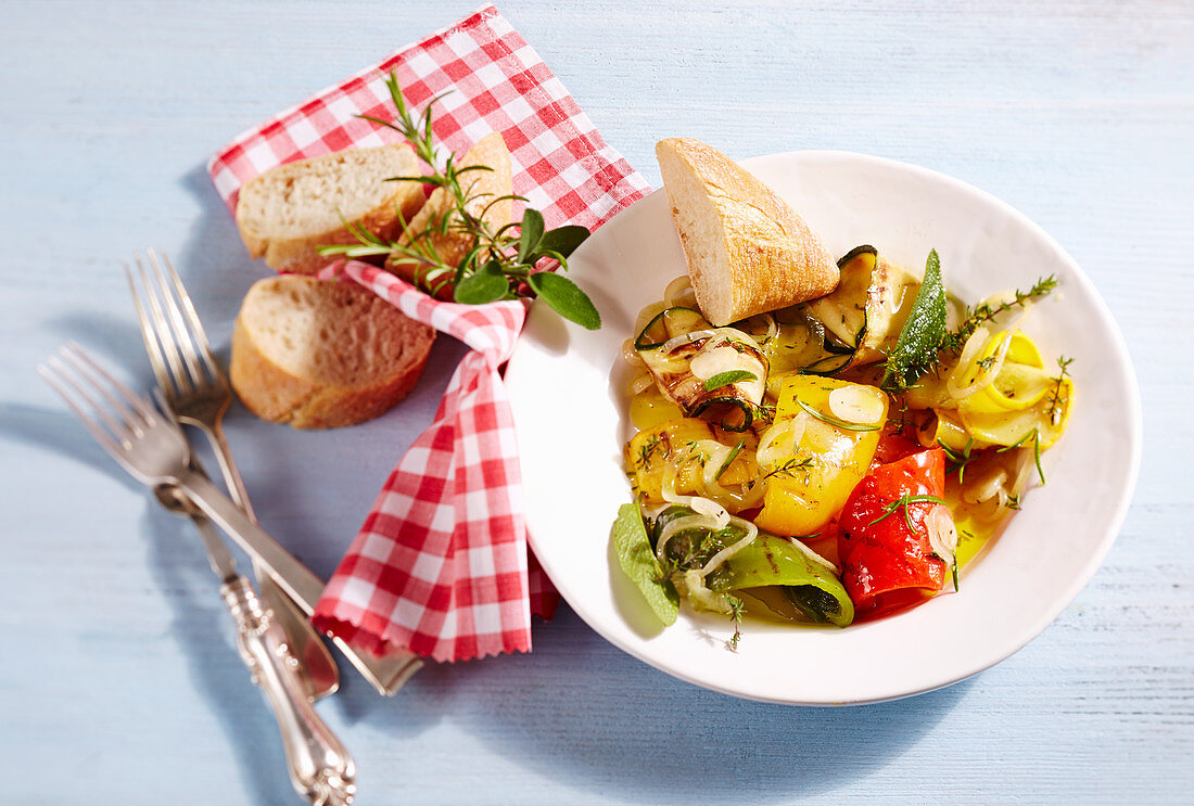 Grilled, pickled Mediterranean vegetables on a plate with a napkin