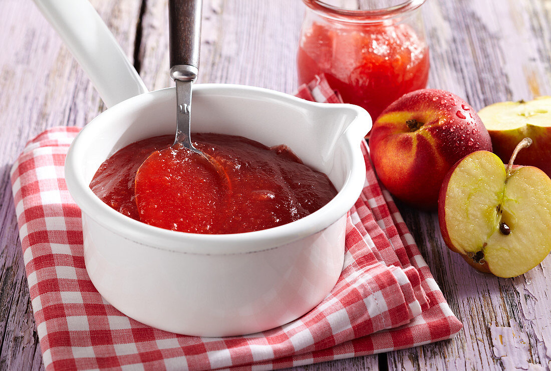 Nectarine and apple jam in a saucepan on a napkin