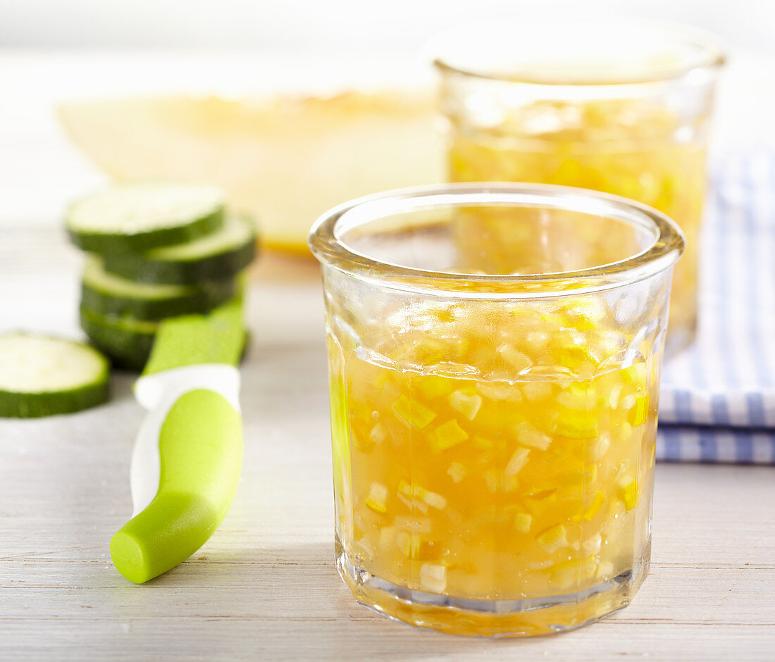 Melon and zucchini jam in a glass with a napkin