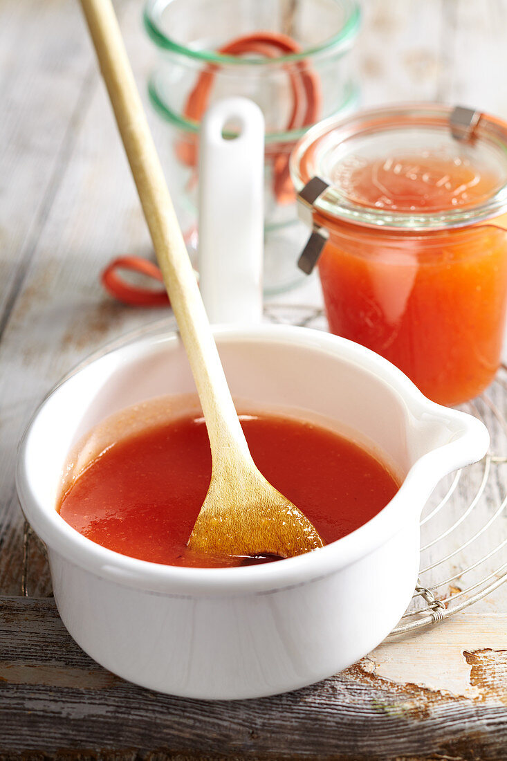 Vineyard peach and orange conserve in a jar and a small enamel saucepan