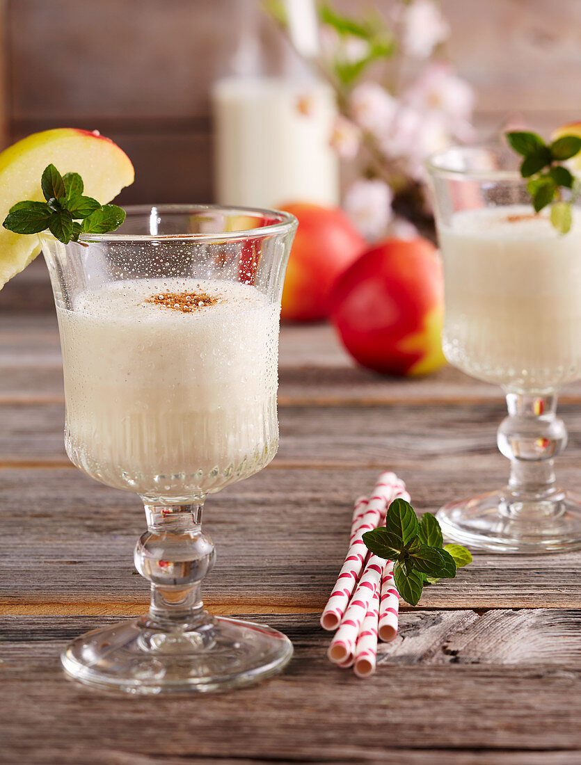 Creamy, cold apple milkshake with vanilla ice cream in glasses