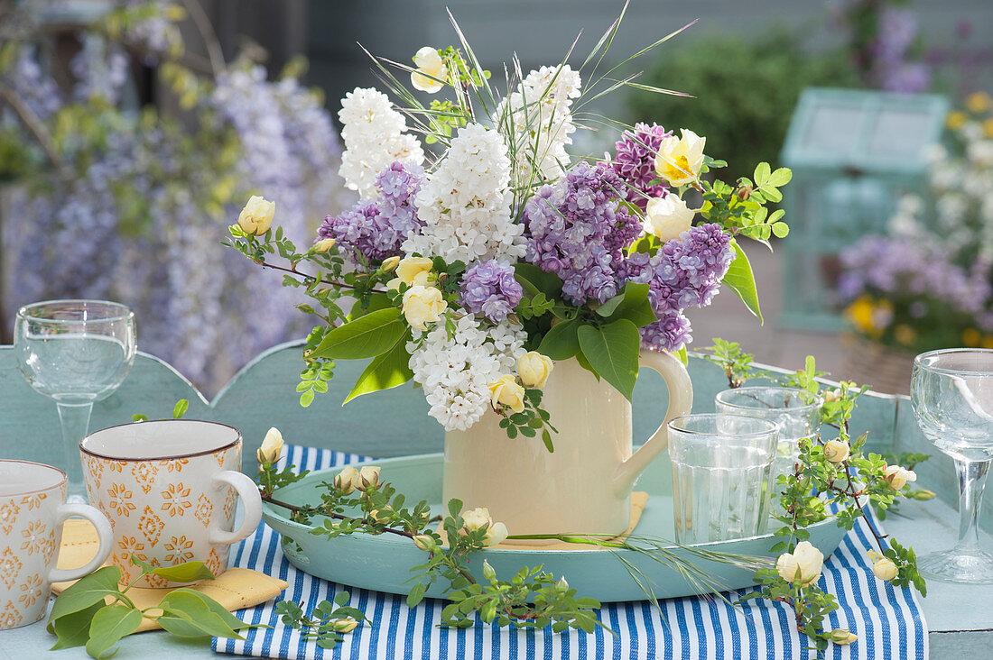 Fragrant bouquet of lilacs and roses on a tray