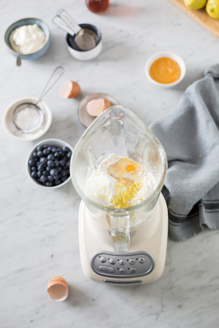 Blueberry pancakes being made: batter ingredients in a blender