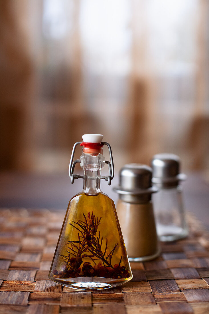 Homemade rosemary oil in a flip-top bottle