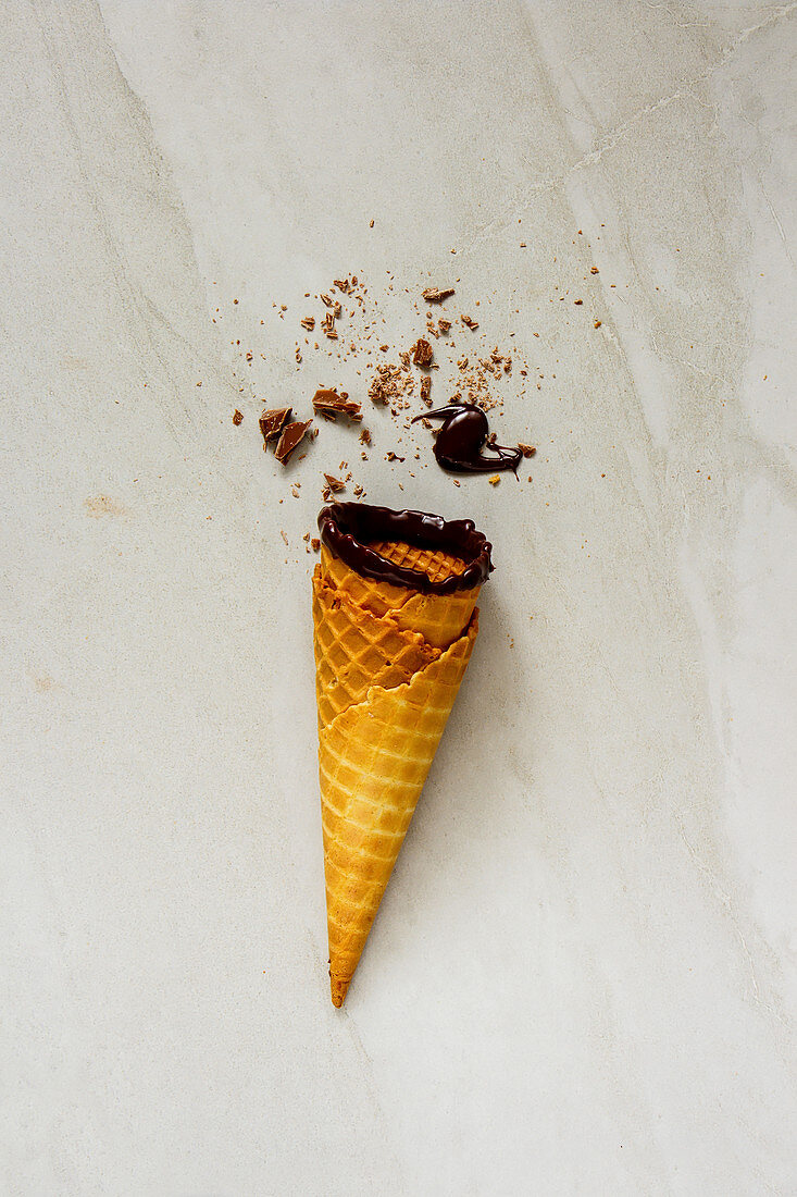 Chocolate sauce dipped ice cream waffle cone