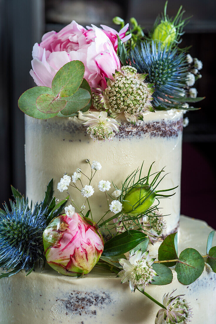 Baking a weddingcake with chocolate cake, vanilla butter cream and raspberrie filling. Decorated with flowers