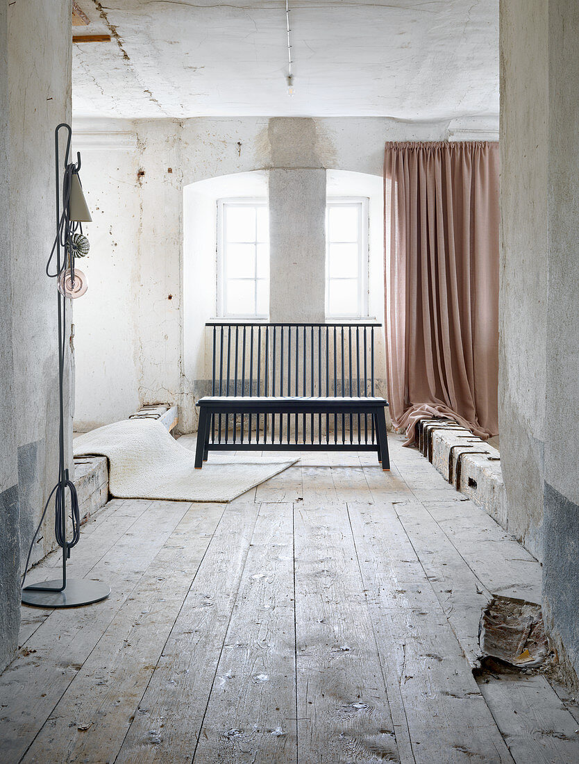 Black wooden bench with upright laths in vintage interior