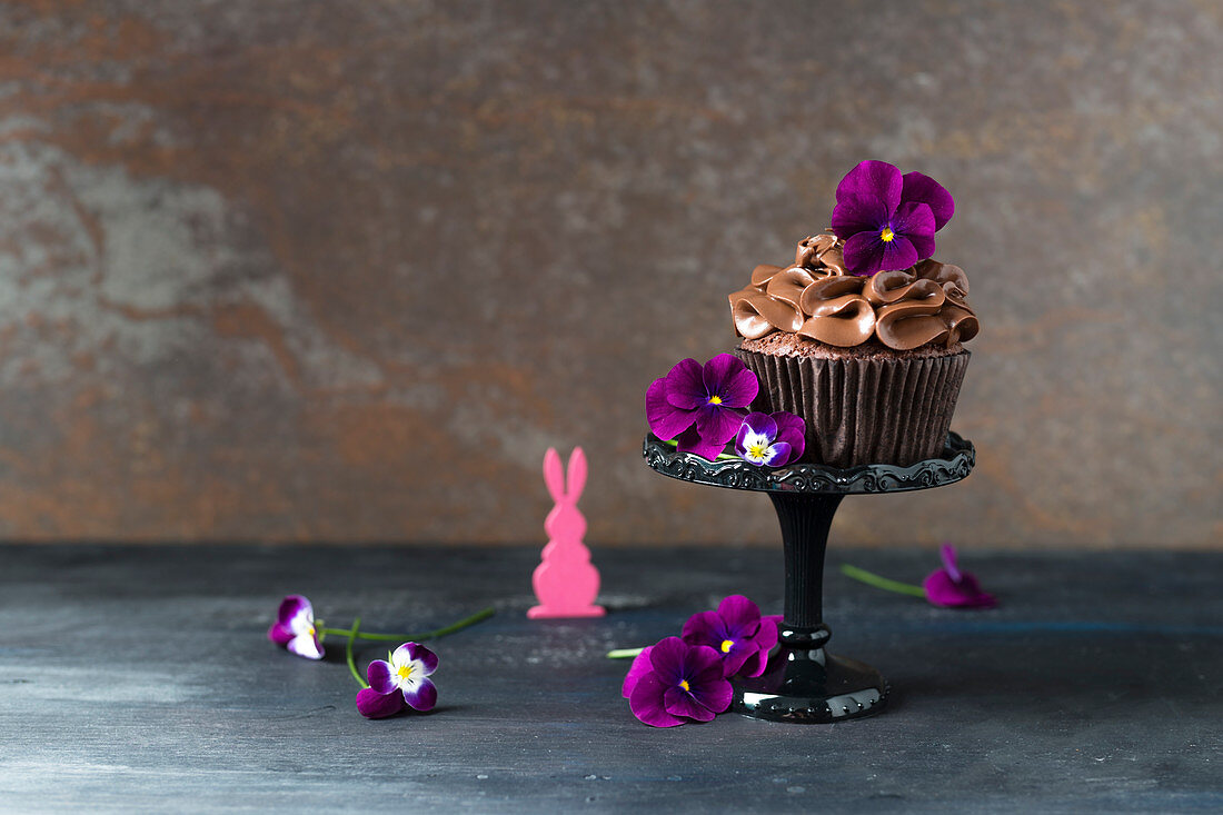 Chocolate cupcake with tufted pansies for Easter