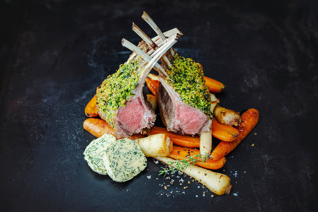 Roasted saddle of lamb with a herb crust and root vegetables