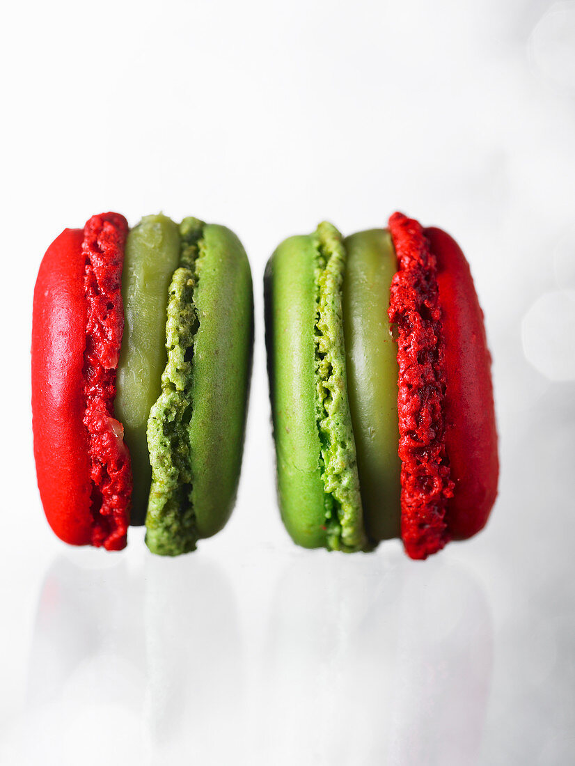 Two red and green macarons