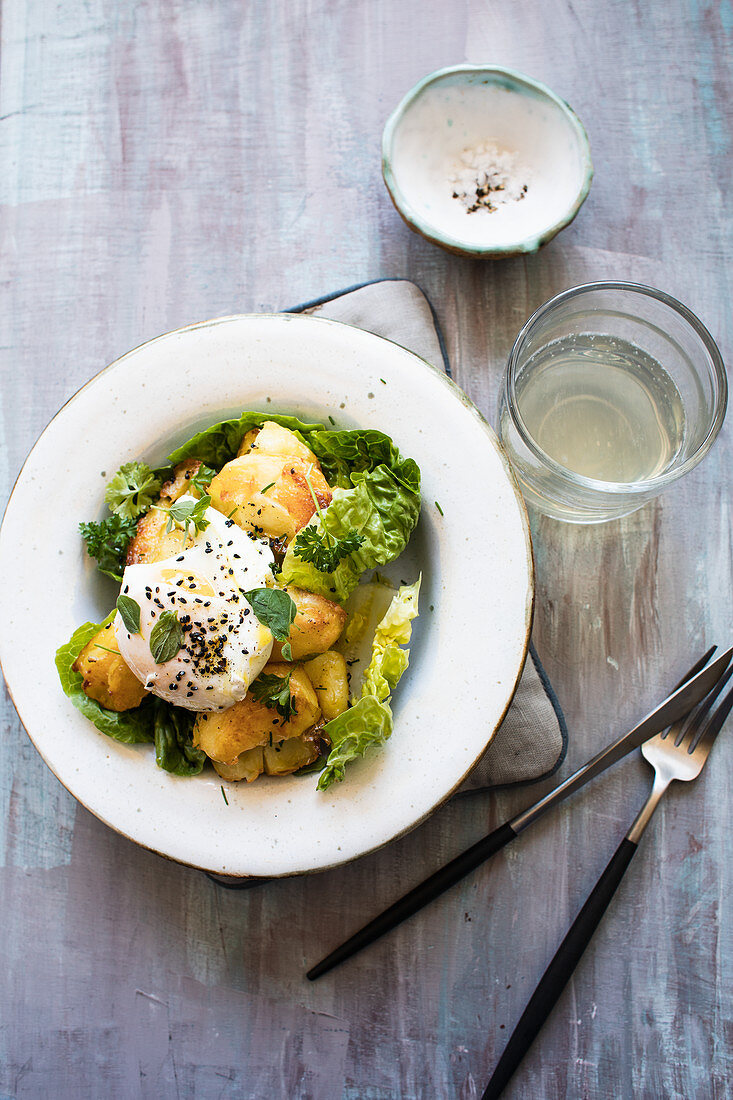 Roasted potato salad with romaine lettuce and poached eggs
