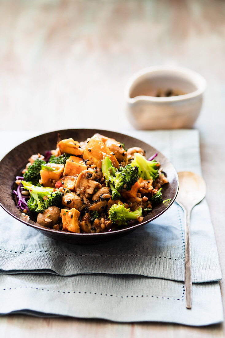 Vegetable salad with fried sweet potatoes, broccoli and mushrooms
