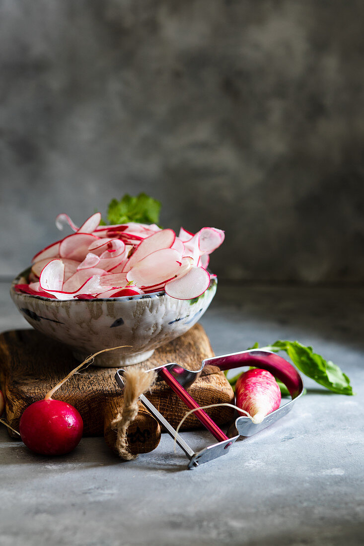 Sliced radishes in ceramic bowls