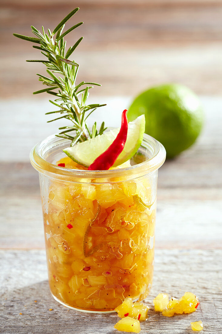 Pineapple chutney with lime, chilli and rosemary in a mason jar