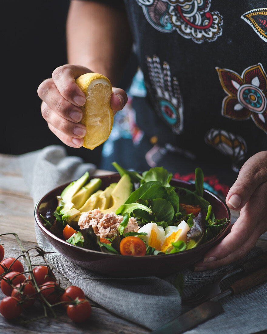 Tuna salad with hard boil egg, avocado, green salad and cherry tomatoes