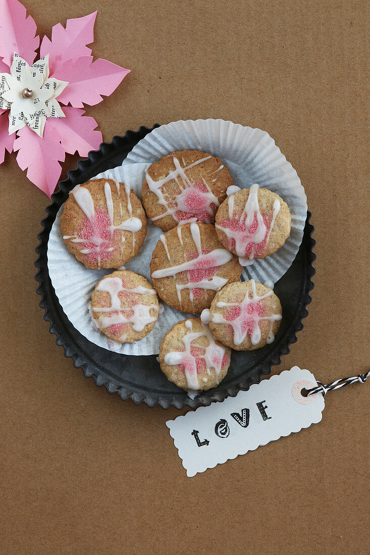 Glutenfreie Kekse mit rosa Zuckerguss und Etikett mit Schriftzug Love