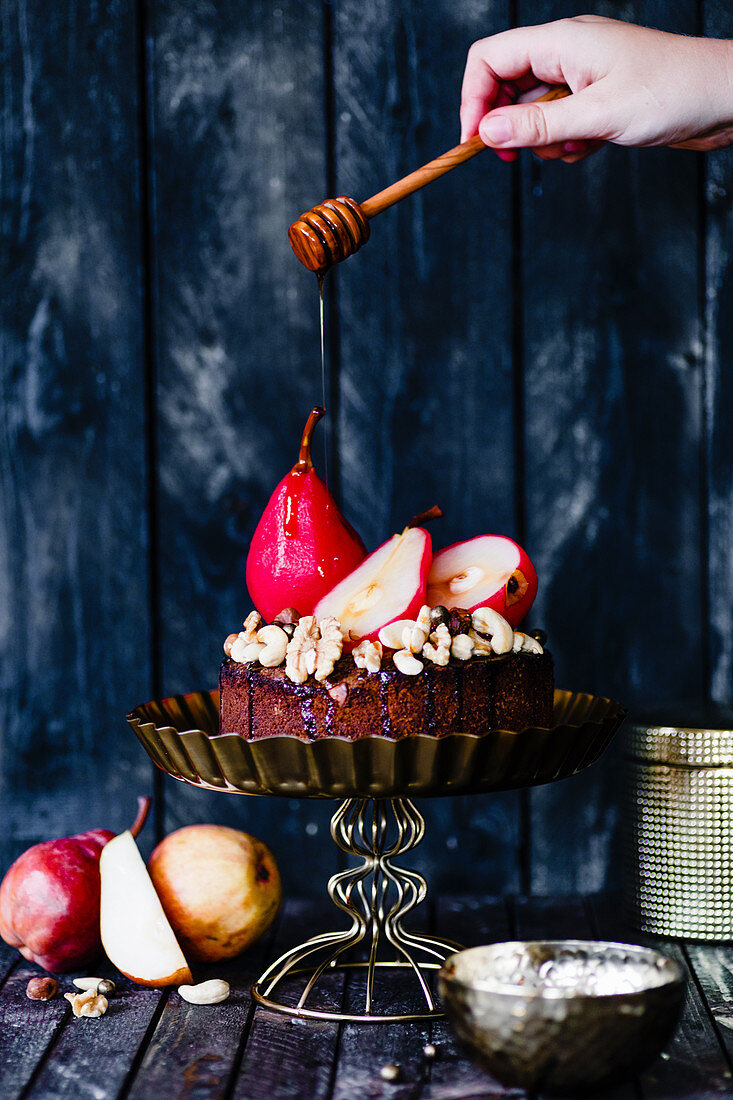 Drizzling a pear and nut cake with syrup