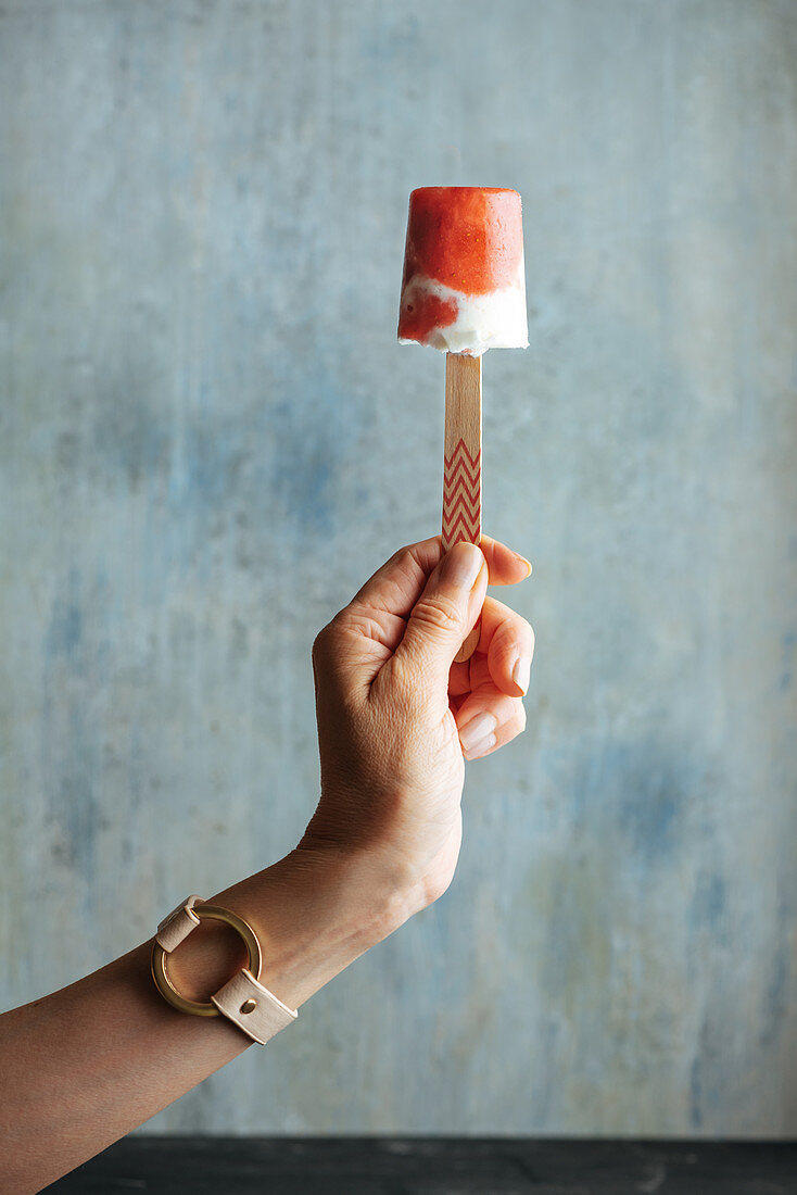 Woman hand holding watermelon and cream popsicle