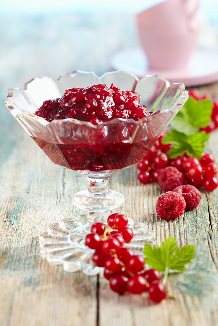 Raspberry and redcurrant jam in a glass bowl