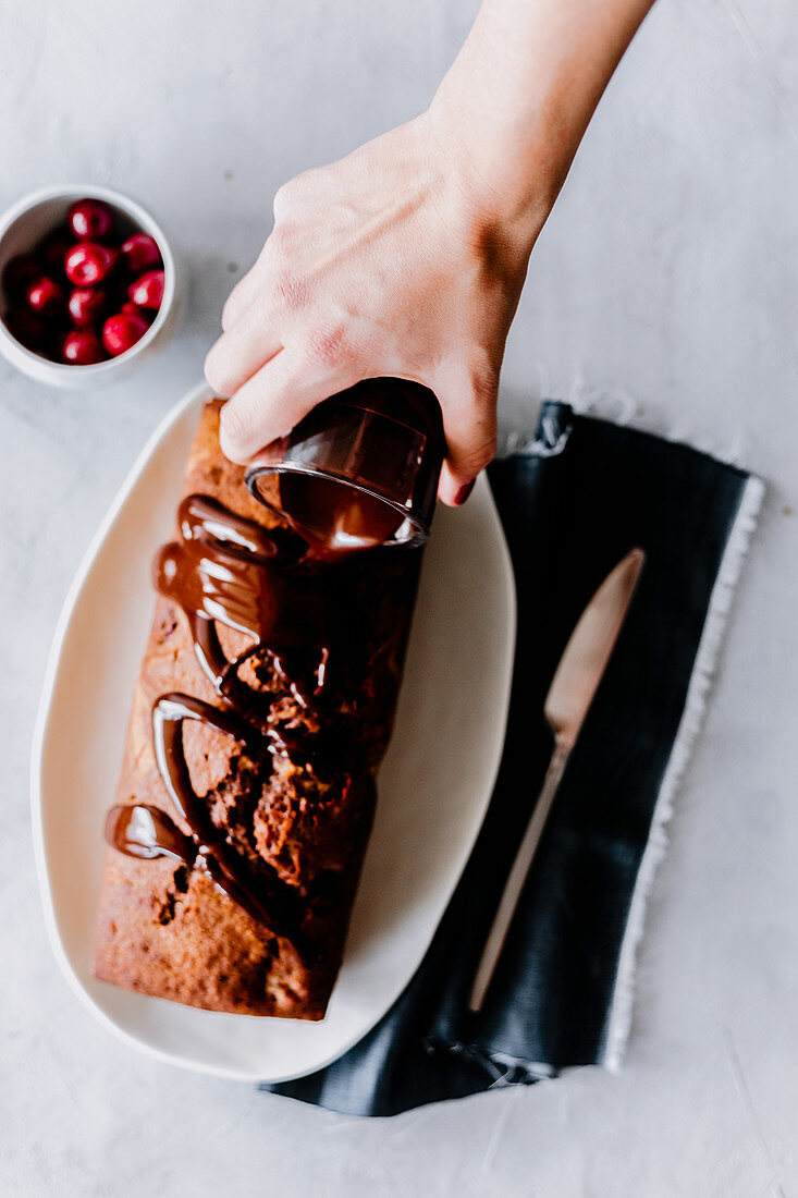 Marble cake with cherries, drizzled with chocolate glaze