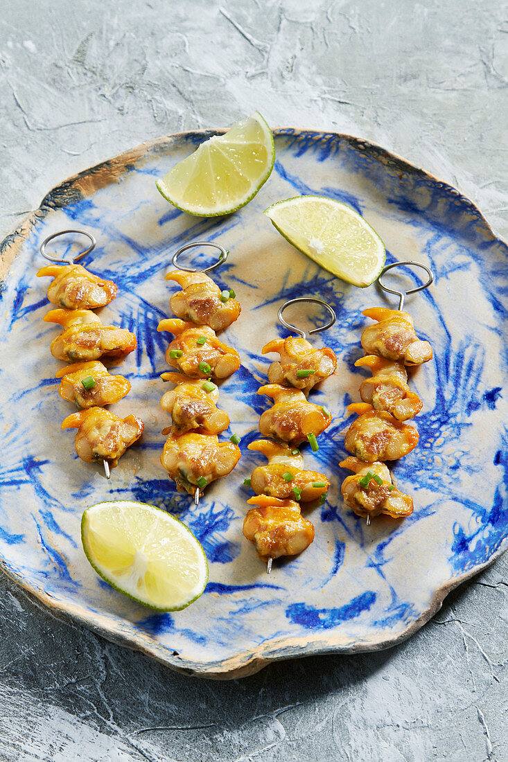 Grilled cockles on skewers