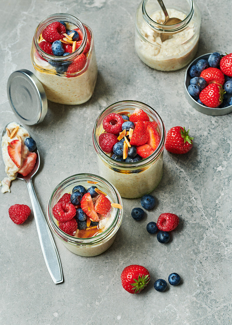 Fruity millet porridge with mixed berries in preserving jars